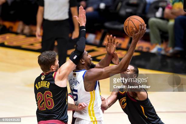 Kevin Durant of the Golden State Warriors attempts a layup defended by Rodney Hood and Kyle Korver of the Cleveland Cavaliers during Game Four of the...
