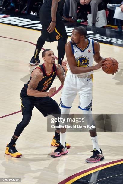 Kevin Durant of the Golden State Warriors looks to pass the ball during the game against George Hill of the Cleveland Cavaliers in Game Four of the...