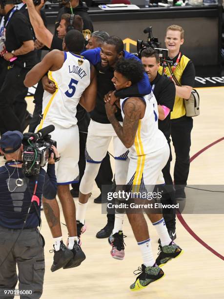 Kevin Durant of the Golden State Warriors celebrates with Kevon Looney and Nick Young after defeating the Cleveland Cavaliers and winning the NBA...