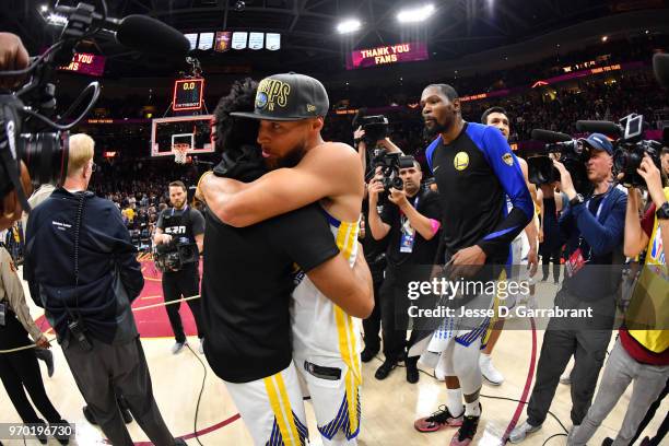 Stephen Curry and Quinn Cook of the Golden State Warriors exchange handshakes after defeating the Cleveland Cavaliers in Game Four of the 2018 NBA...