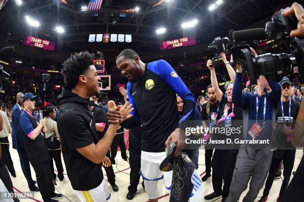 Quinn Cook and Kevin Durant of the Golden State Warriors exchange a handshake after defeating the Cleveland Cavaliers in Game Four of the 2018 NBA...