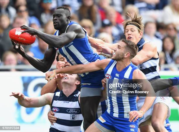 Majak Daw of the Kangaroos marks during the round 12 AFL match between the Geelong Cats and the North Melbourne Kangaroos at GMHBA Stadium on June 9,...