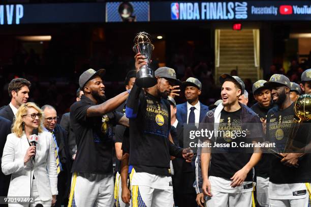 Kevin Durant of the Golden State Warriors holds the Bill Russell Finals MVP trophy after defeating the Cleveland Cavaliers in Game Four of the 2018...