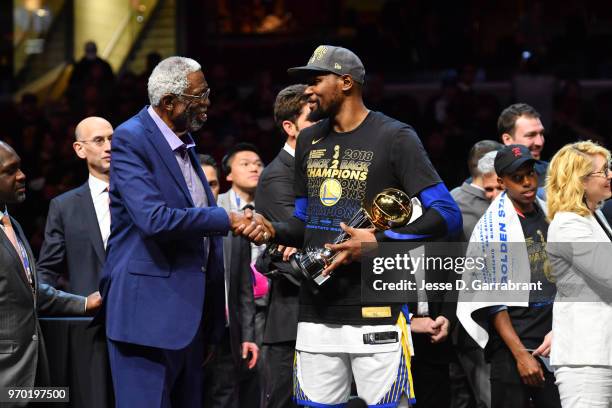 Bill Russell exchanges handshakes with Kevin Durant of the Golden State Warriors after Durant received the Bill Russell Finals MBP Trophy by...