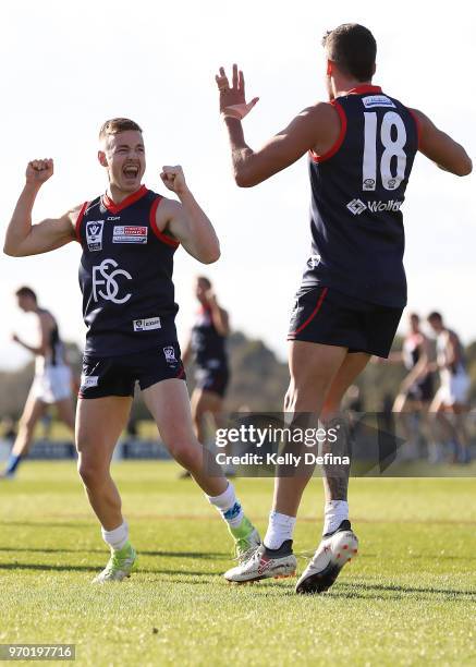 Angus Scott of the Demons celebrates his goal with Harley Balic of the Demons during the round 10 VFL match between Collingwood and Casey at Casey...