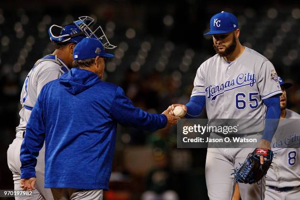 Jakob Junis of the Kansas City Royals is relieved by manager Ned Yost during the sixth inning against the Oakland Athletics at the Oakland Coliseum...