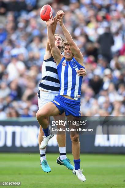 Jake Kolodjashnij of the Cats spoils a mark by Mason Wood of the Kangaroos during the round 12 AFL match between the Geelong Cats and the North...