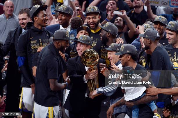 Golden State Warriors owners Joe Lacob and Peter Guber celebrate with the team while holding the Larry O'Brien NBA Championship Trophy after the game...