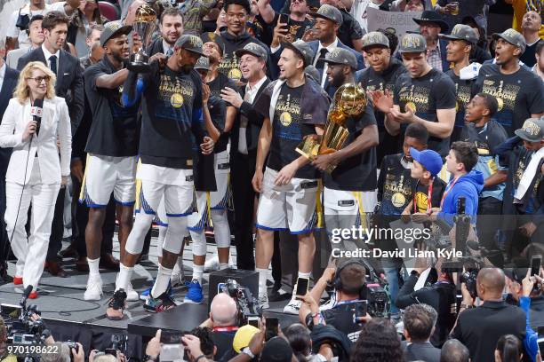 The Golden State Warriors celebrate as Kevin Durant wins the Bill Russell NBA Finals Most Valuable Player Trophy while the team holds the Larry...