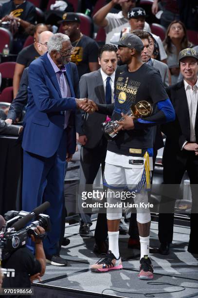Kevin Durant of the Golden State Warriors shakes the hand of Bill Russell as he accepts the Bill Russell NBA Finals Most Valuable Player Trophy after...