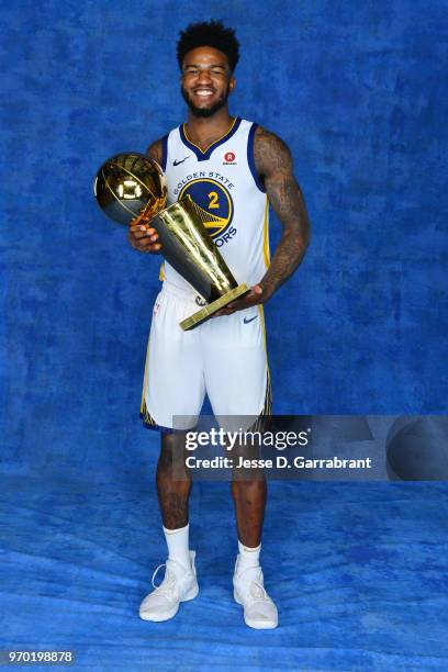 Jordan Bell of the Golden State Warriors poses for a portrait with the Larry O'Brien Championship trophy after defeating the Cleveland Cavaliers in...