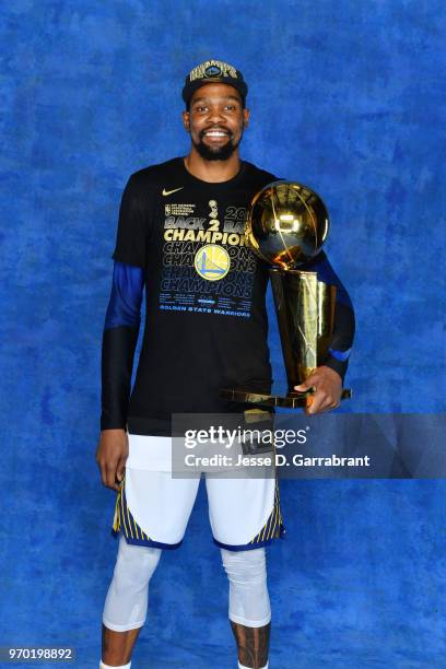 Kevin Durant of the Golden State Warriors poses for a portrait with the Larry O'Brien Championship trophy after defeating the Cleveland Cavaliers in...