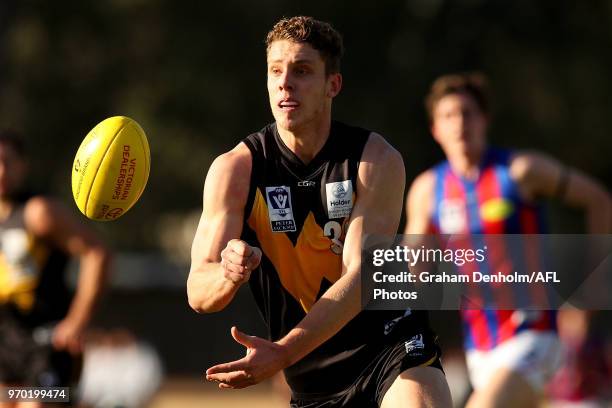 Josh Corbett of Werribee handballs during the round 10 VFL match between Werribee and Port Melbourne at Avalon Airport Oval on June 9, 2018 in...
