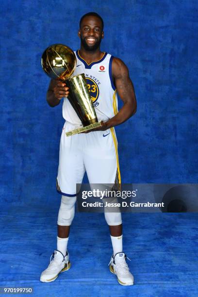 Draymond Green of the Golden State Warriors poses for a portrait with the Larry O'Brien Championship trophy after defeating the Cleveland Cavaliers...