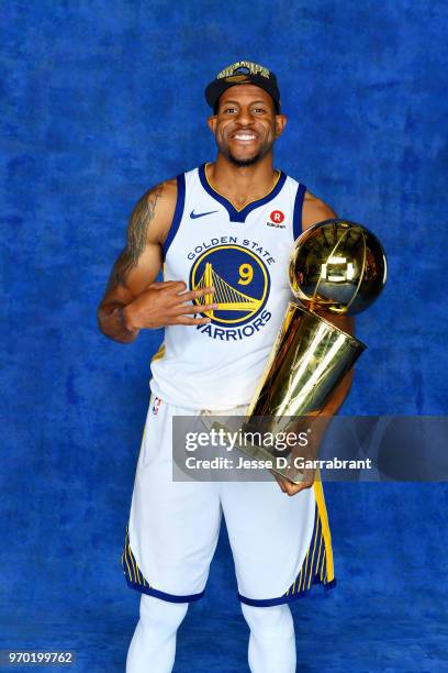 Andre Iguodala of the Golden State Warriors poses for a portrait with the Larry O'Brien Championship trophy after defeating the Cleveland Cavaliers...