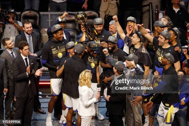 Stephen Curry of the Golden State Warriors celebrates on stage with the Larry O'Brien Championship Trophy after winning Game Four of the 2018 NBA...