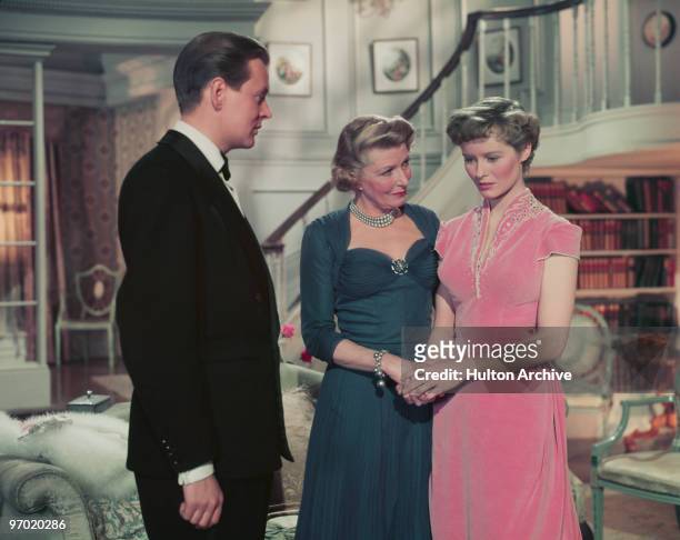 Jack Watling , Heather Thatcher and Virginia McKenna in a scene from the British comedy film 'Father's Doing Fine', directed by Henry Cass, 1952.