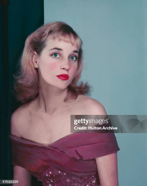 English actress Sylvia Syms wearing an off-the-shoulder dress, circa 1955.