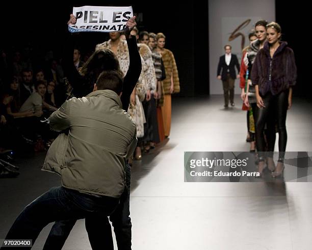 Animals rights campaigners protest against the use of fur in the garments with the slogan 'fur is murder' at Jesus Lorenzo show during Cibeles Madrid...