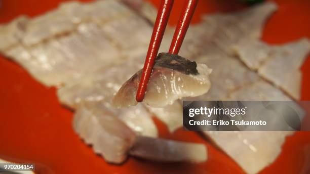 pov food chopstick picking up vinegar-marinated aji fish (japanese horse mackerel) - trachurus trachurus stockfoto's en -beelden