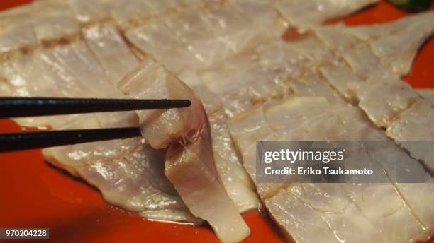 pov food chopstick picking up vinegar-marinated aji fish (japanese horse mackerel) - trachurus trachurus stockfoto's en -beelden