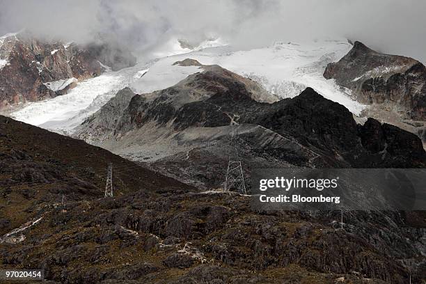 Pylons and transmission wires carry electricity generated by Cia Boliviana de Energia Eleca SA hydroelectric plants past the Huayna Potosi glacier in...