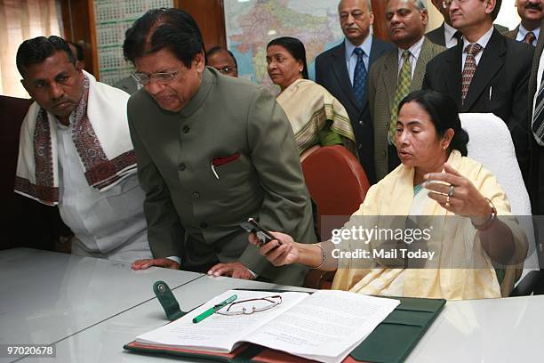 Indian Railway Minister Mamata Banerjee with 2010 the railway budget file as Minister of State for Railways K. H. Muniyappa and E. Ahmed look on in...