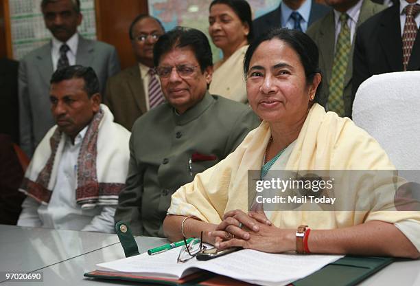 Indian Railway Minister Mamata Banerjee with 2010 the railway budget file as Minister of State for Railways K. H. Muniyappa and E. Ahmed look on in...