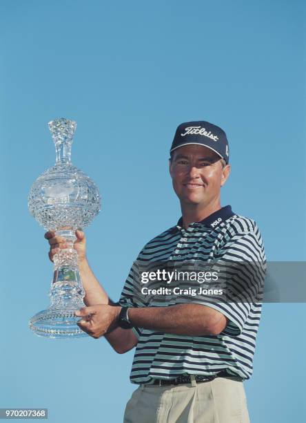 Davis Love III of the United States holds the trophy after winning the AT&T Pebble Beach Pro-Am golf tournament on 4 February 2001 at the Pebble...