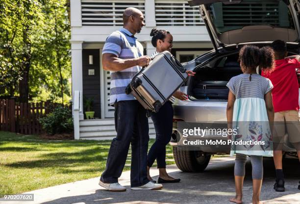 family loading car for vacation - luggage trunk stock-fotos und bilder