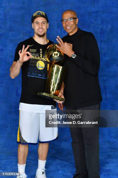 Klay Thompson of the Golden State Warriors and his father Mychal Thompson pose for a portrait with the Larry O'Brien Championship trophy after...