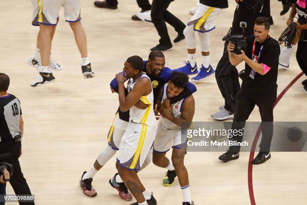 Kevin Durant, Kevon Looney and Nick Young of the Golden State Warriors celebrate on court after winning Game Four of the 2018 NBA Finals against the...