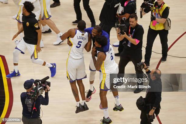 Kevin Durant, Kevon Looney and Nick Young of the Golden State Warriors celebrate on court after winning Game Four of the 2018 NBA Finals against the...