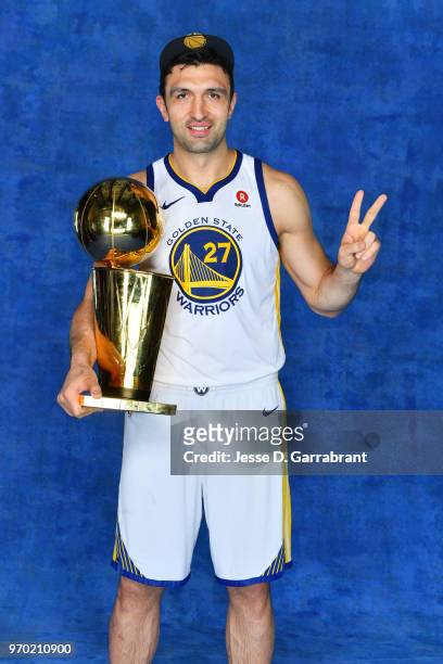Zaza Pachulia of the Golden State Warriors poses for a portrait with the Larry O'Brien Championship trophy after defeating the Cleveland Cavaliers in...