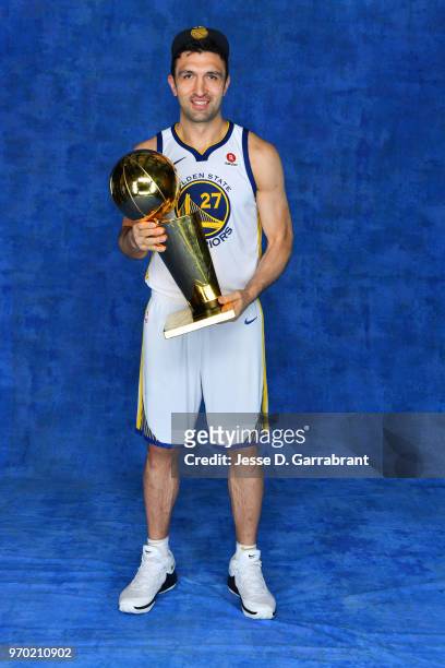 Zaza Pachulia of the Golden State Warriors poses for a portrait with the Larry O'Brien Championship trophy after defeating the Cleveland Cavaliers in...