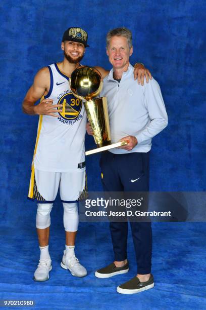 Stephen Curry and Head Coach Steve Kerr of the Golden State Warriors pose for a portrait with the Larry O'Brien Championship trophy after defeating...