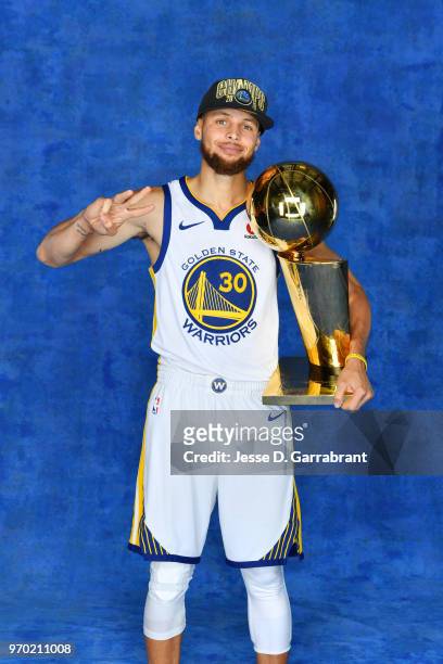 Stephen Curry of the Golden State Warriors poses for a portrait with the Larry O'Brien Championship trophy after defeating the Cleveland Cavaliers in...
