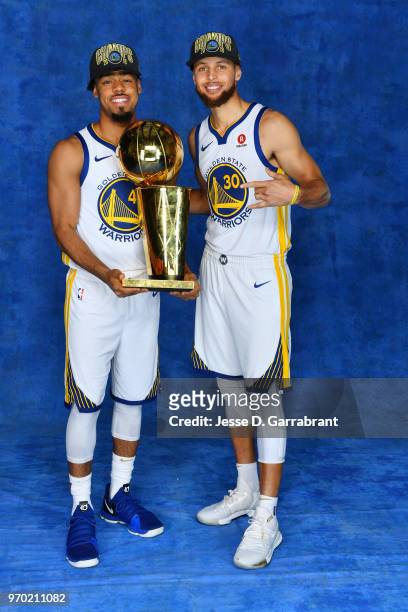 Quinn Cook and Stephen Curry of the Golden State Warriors poses for a portrait with the Larry O'Brien Championship trophy after defeating the...