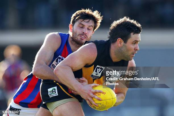 Andrew Hooper of Werribee is tackled during the round 10 VFL match between Werribee and Port Melbourne at Avalon Airport Oval on June 9, 2018 in...