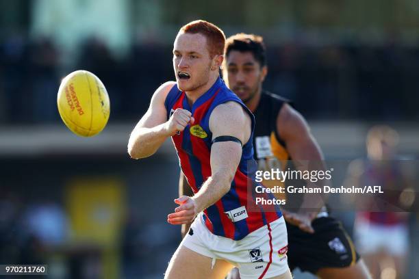Anthony Anastasio of Port Melbourne handballs during the round 10 VFL match between Werribee and Port Melbourne at Avalon Airport Oval on June 9,...