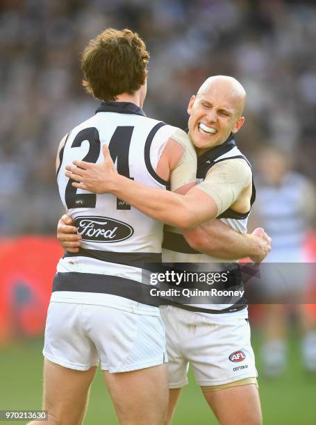 Jed Bews and Gary Ablett of the Cats celebrate a goal during the round 12 AFL match between the Geelong Cats and the North Melbourne Kangaroos at...