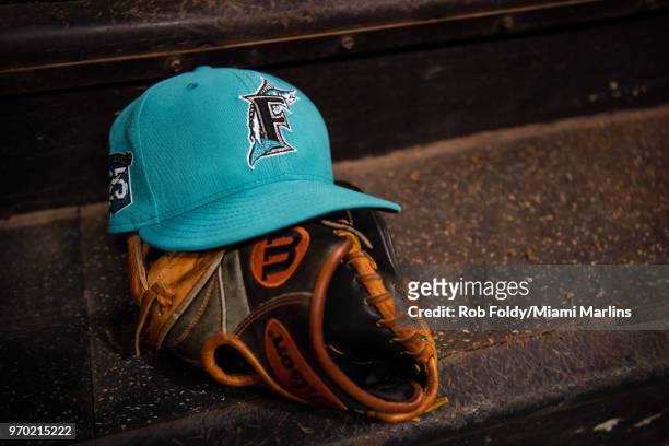 Detailed view of a throwback Florida Marlins hat sitting on the stairs of the dugout during the game between the Miami Marlins and the San Diego...