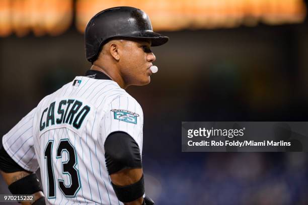 Starlin Castro of the Miami Marlins blows a bubble as he stands on third base during the game against the San Diego Padres at Marlins Park on June 8,...