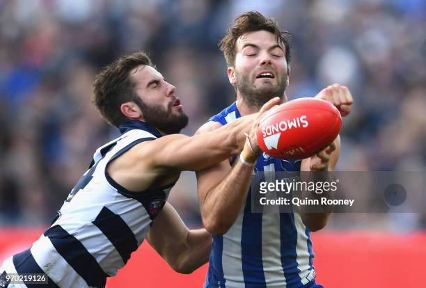 James Parsons of the Cats spoils a mark by Luke McDonald of the Kangaroos during the round 12 AFL match between the Geelong Cats and the North...