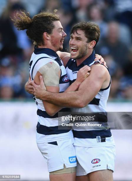 Wylie Buzza and Tom Hawkins of the Cats celebrate a goal during the round 12 AFL match between the Geelong Cats and the North Melbourne Kangaroos at...