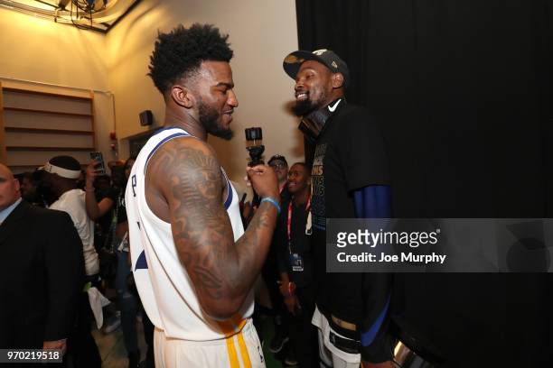 Jordan Bell of the Golden State Warriors and Kevin Durant of the Golden State Warriors talk during post-game portraits after Game Four of the 2018...