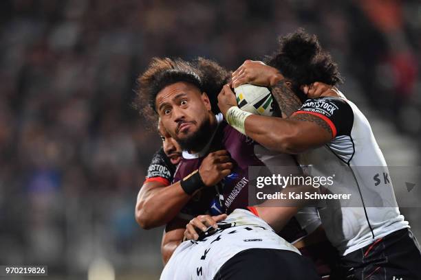 Jorge Taufua of the Sea Eagles is tackled during the round 14 NRL match between the Manly Sea Eagles and the New Zealand Warriors at AMI Stadium on...