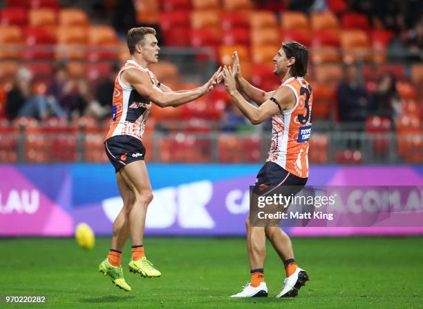 Zac Langdon of the Giants celebrates with Ryan Griffen of the Giants after kicking a goal during the round 12 AFL match between the Greater Western...