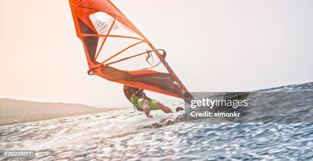 windsurfing in sea - windsurfing stock pictures, royalty-free photos & images