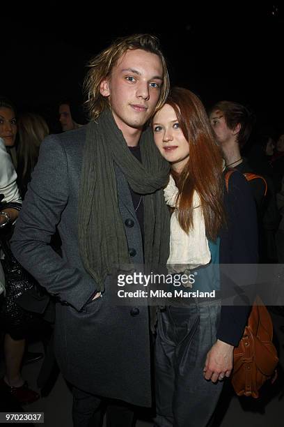 Jamie Campbell Bower and Bonnie Wright pose on the front row at the Burberry Prorsum show for London Fashion Week Autumn/Winter 2010 at on February...